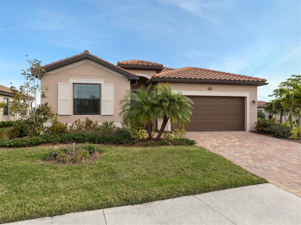 a front view of a house with a yard and garage