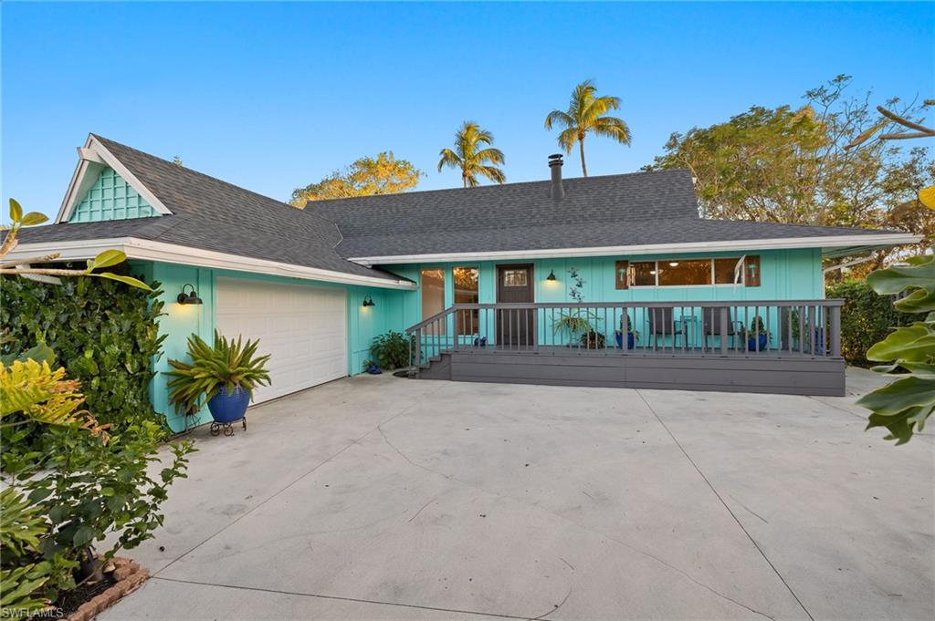 Ranch-style house with covered porch and a garage