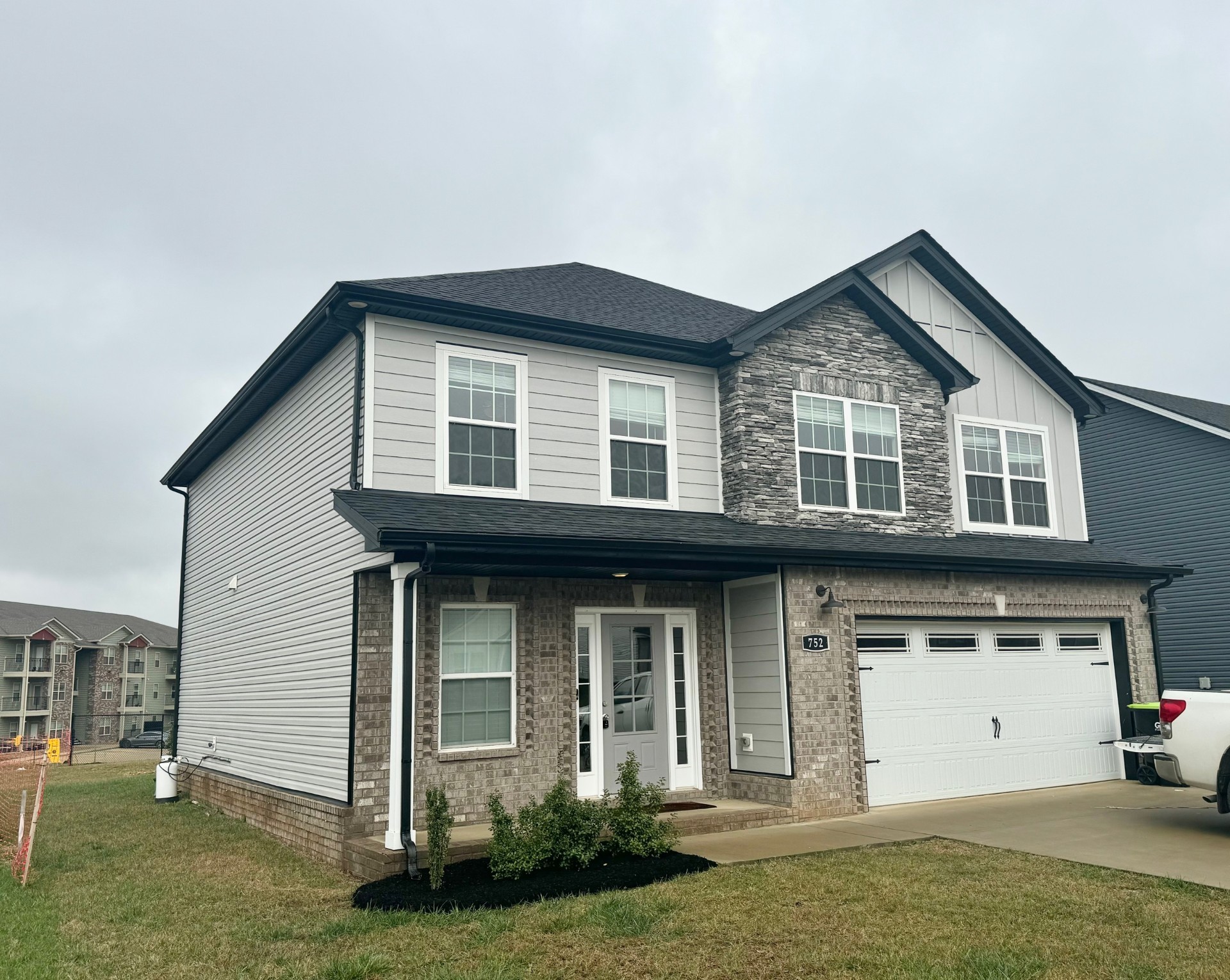 a front view of a house with a yard and garage