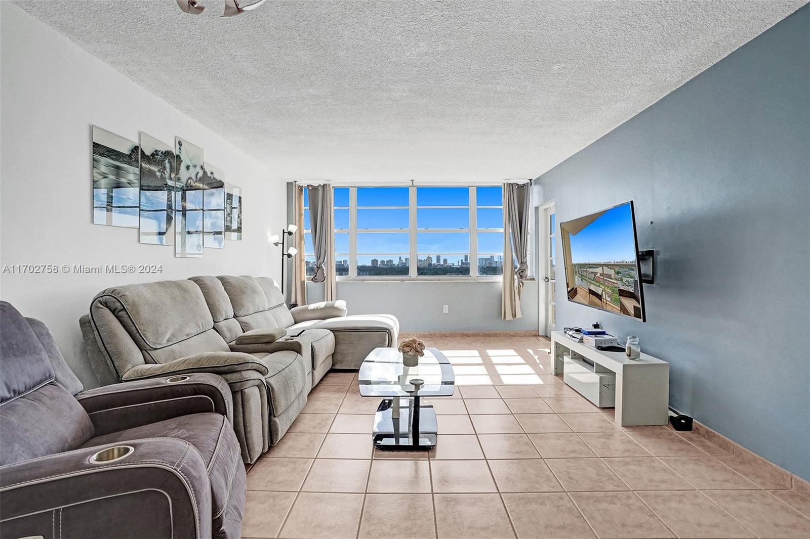 a living room with furniture and a flat screen tv