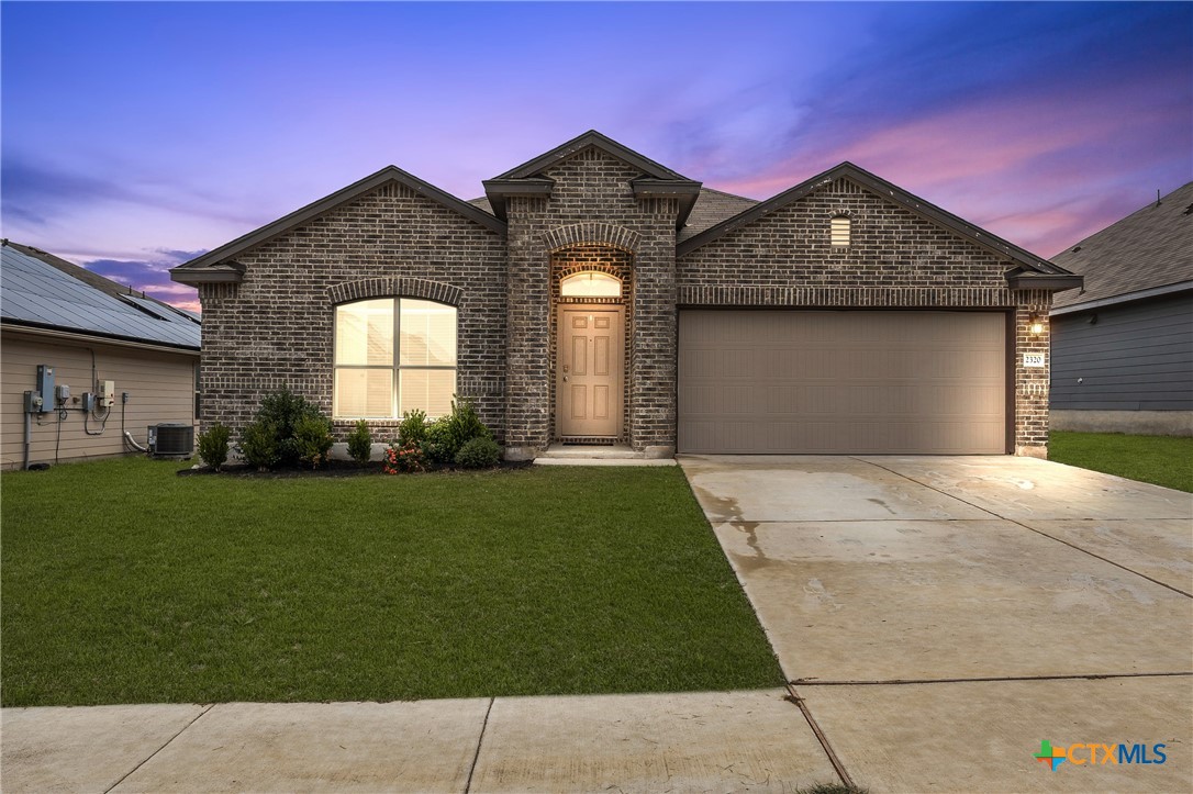 a front view of a house with a yard