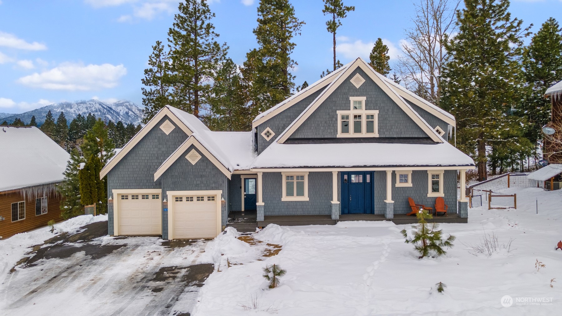 a view of a house with a yard covered in snow