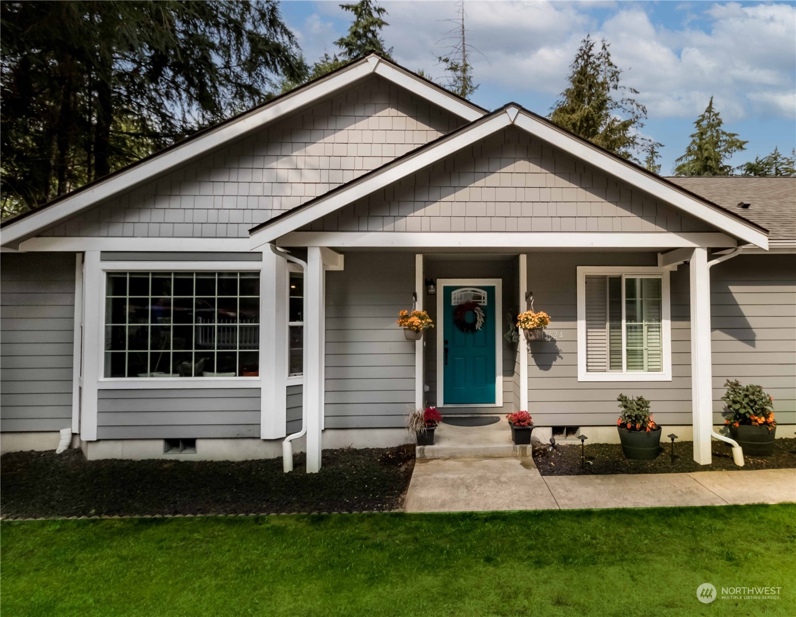 a front view of a house with a garden