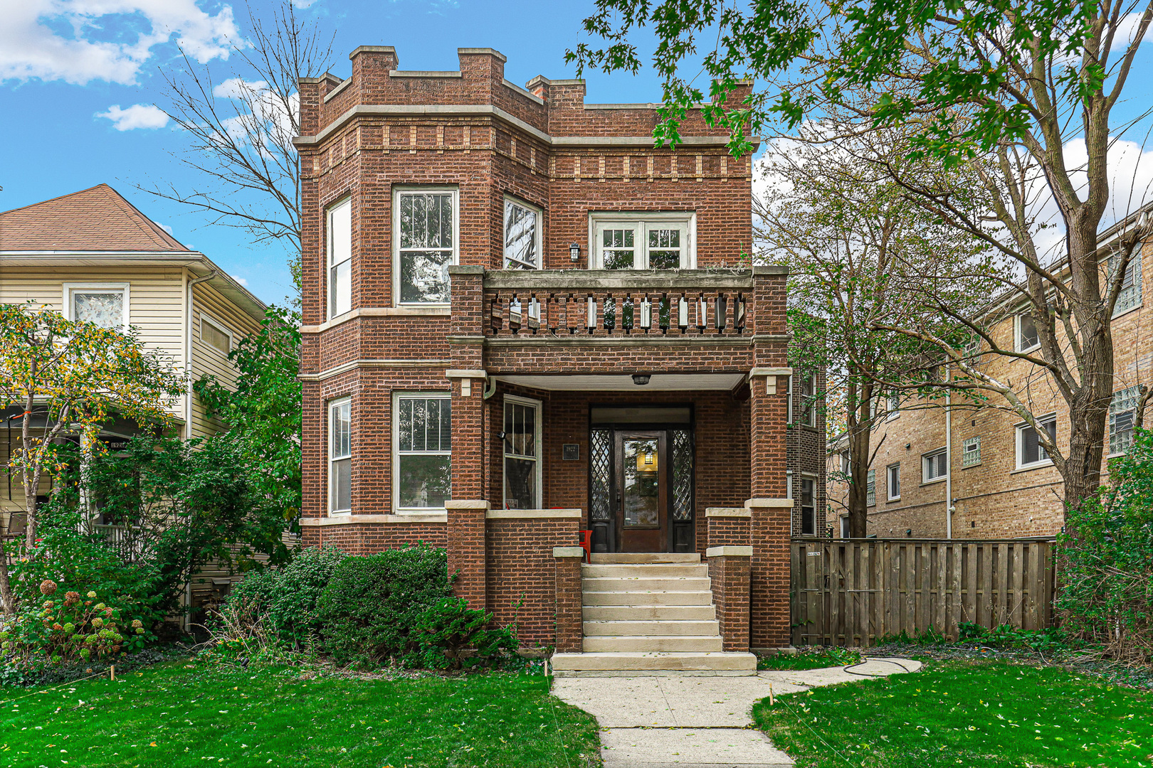 a front view of a house with a garden