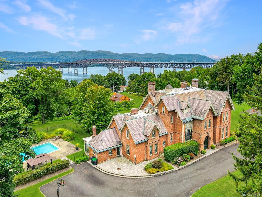 an aerial view of a house with a garden and lake view