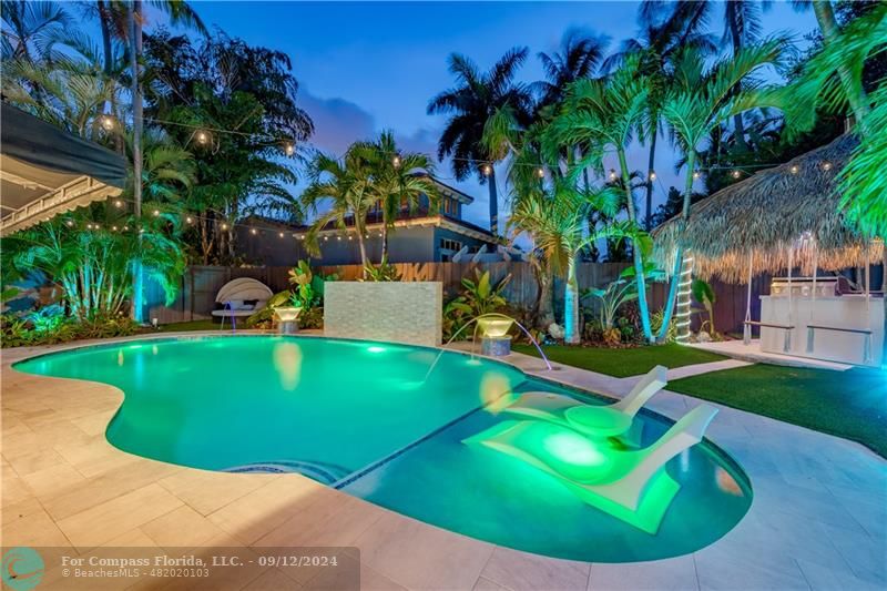 a view of a backyard with swimming pool