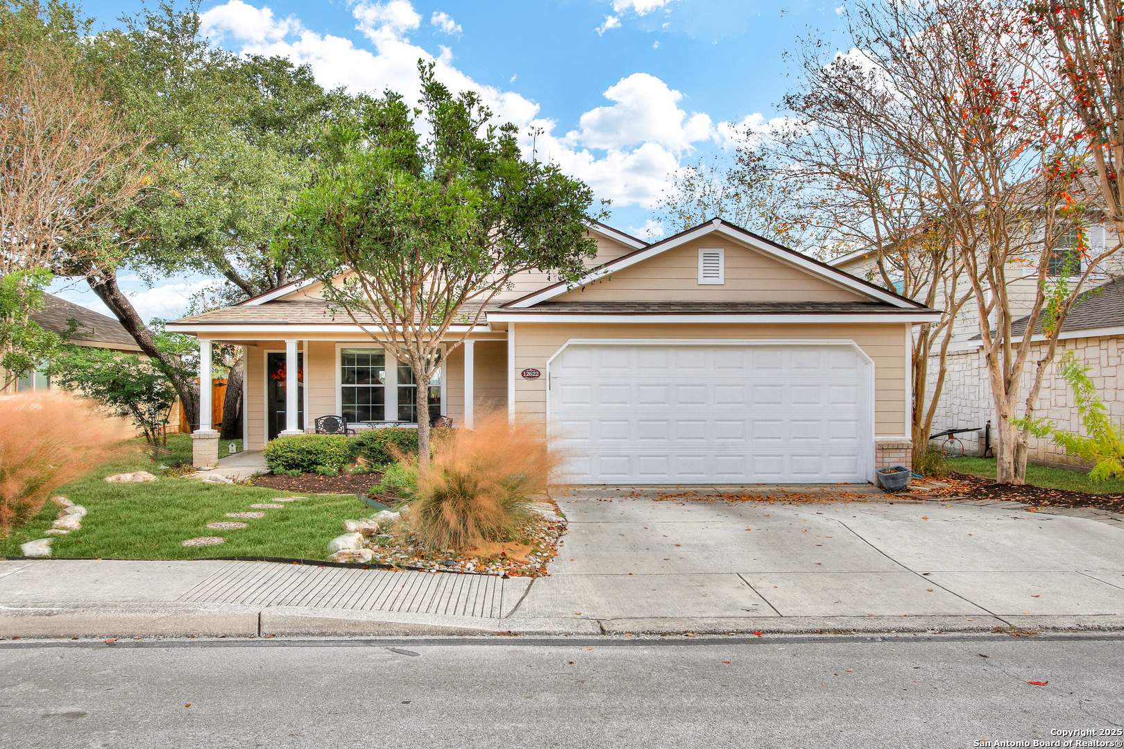 a front view of a house with a yard and garage