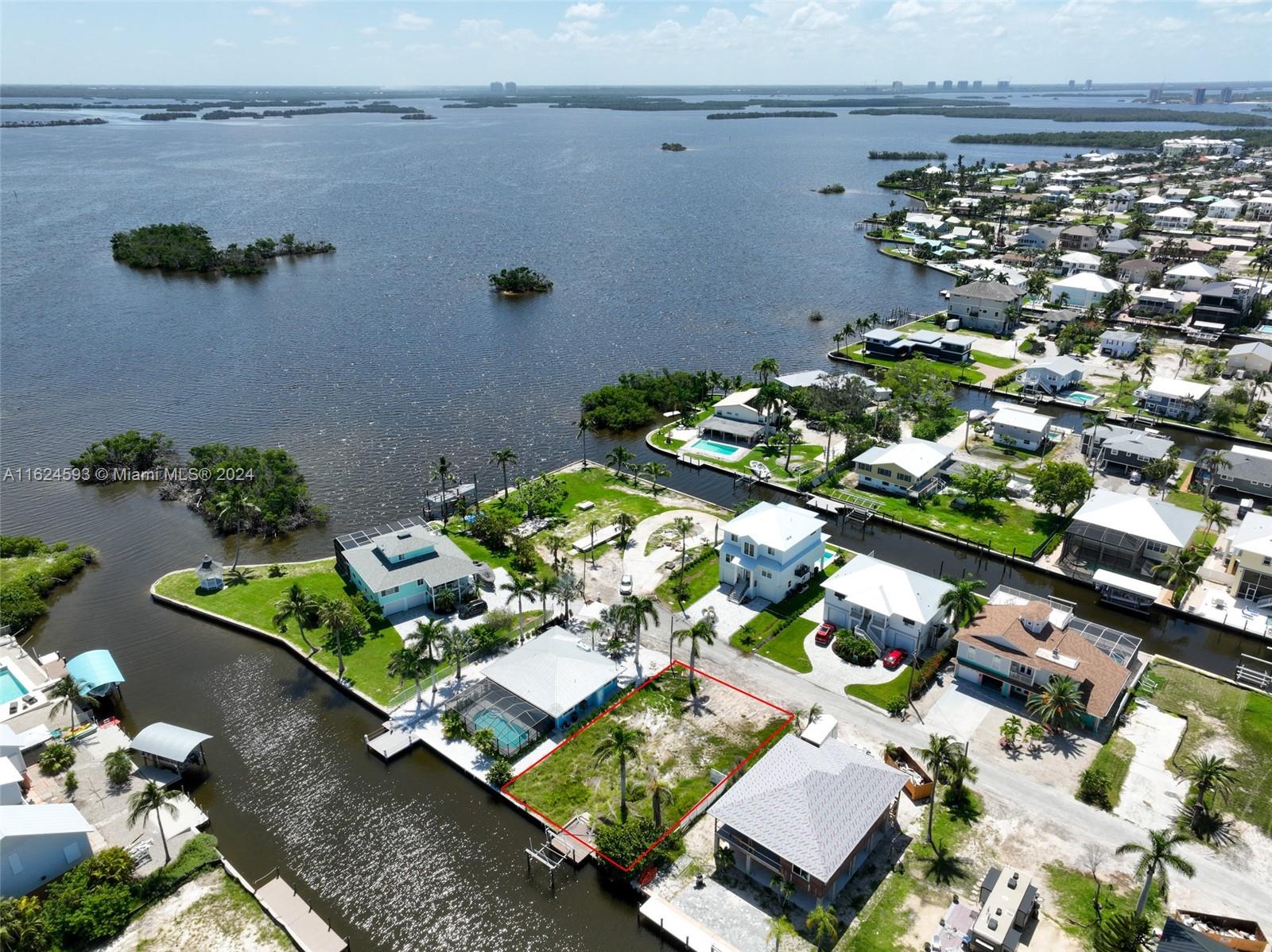 an aerial view of a residential houses with yard