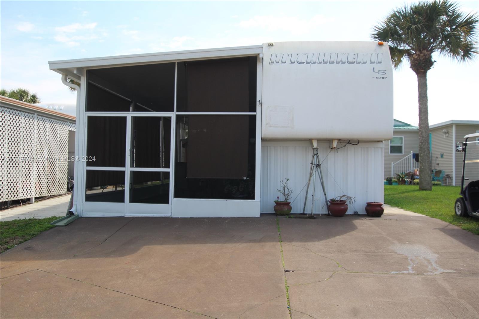 a view of an entrance to house with yard and garage