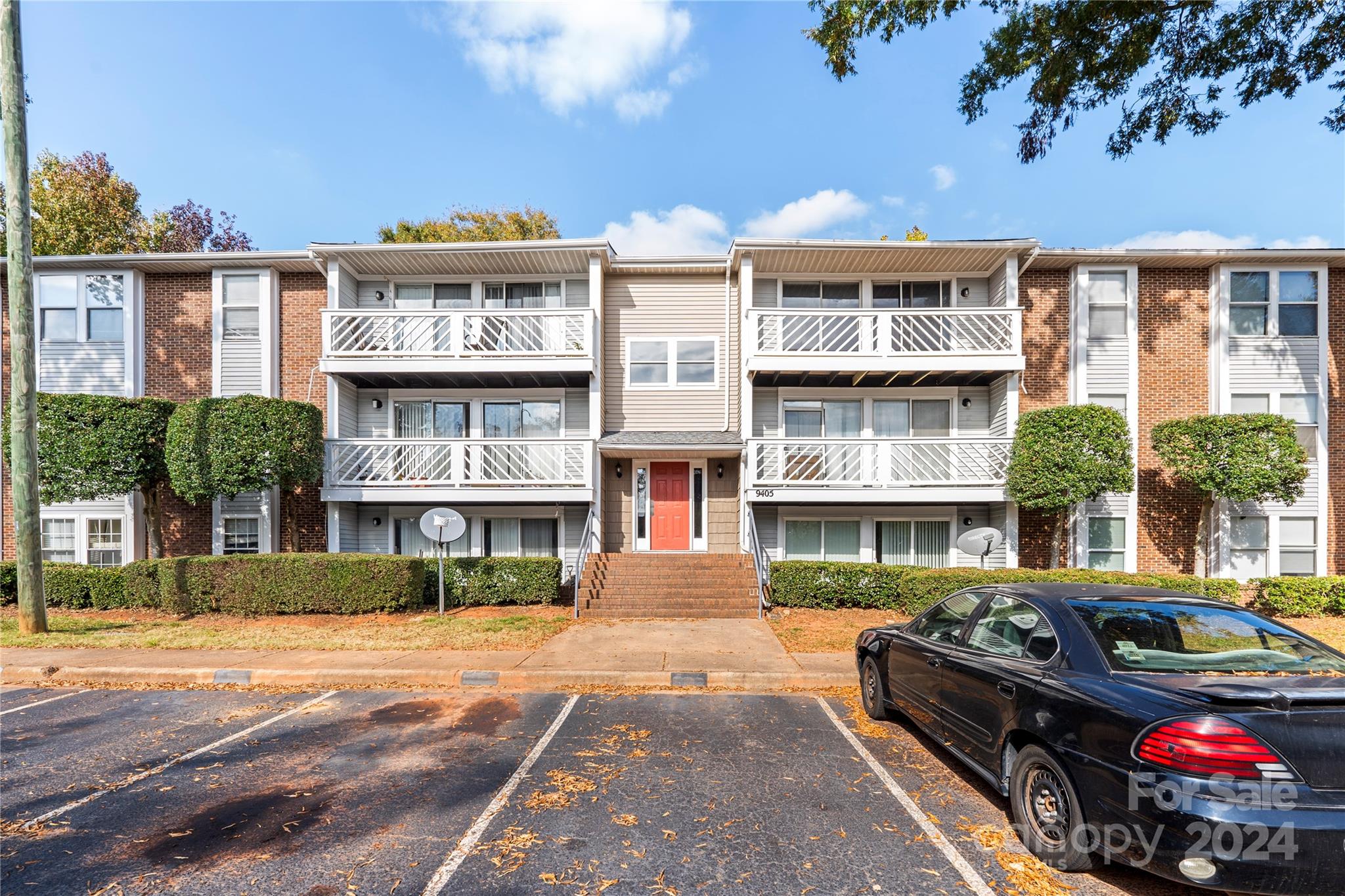 a front view of a residential apartment building with a yard