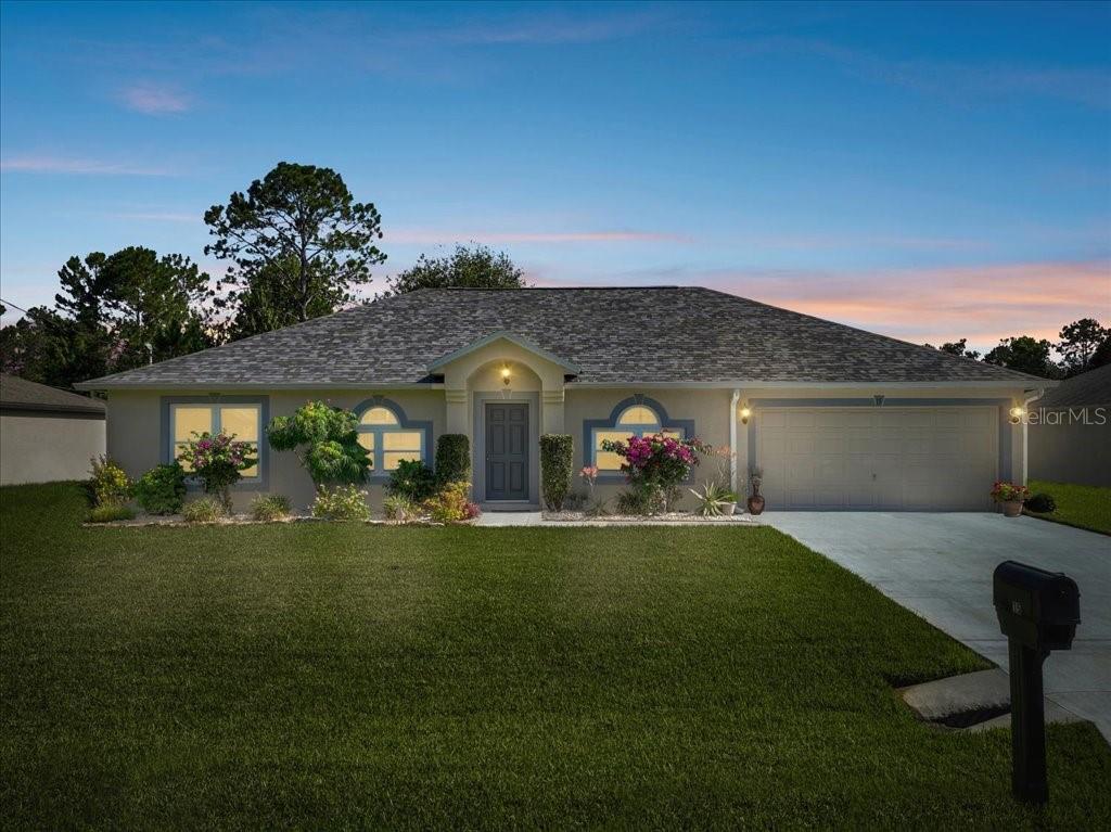 a front view of a house with a garden