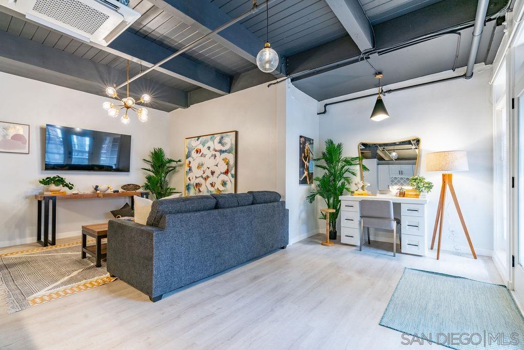 a living room with furniture and a flat screen tv