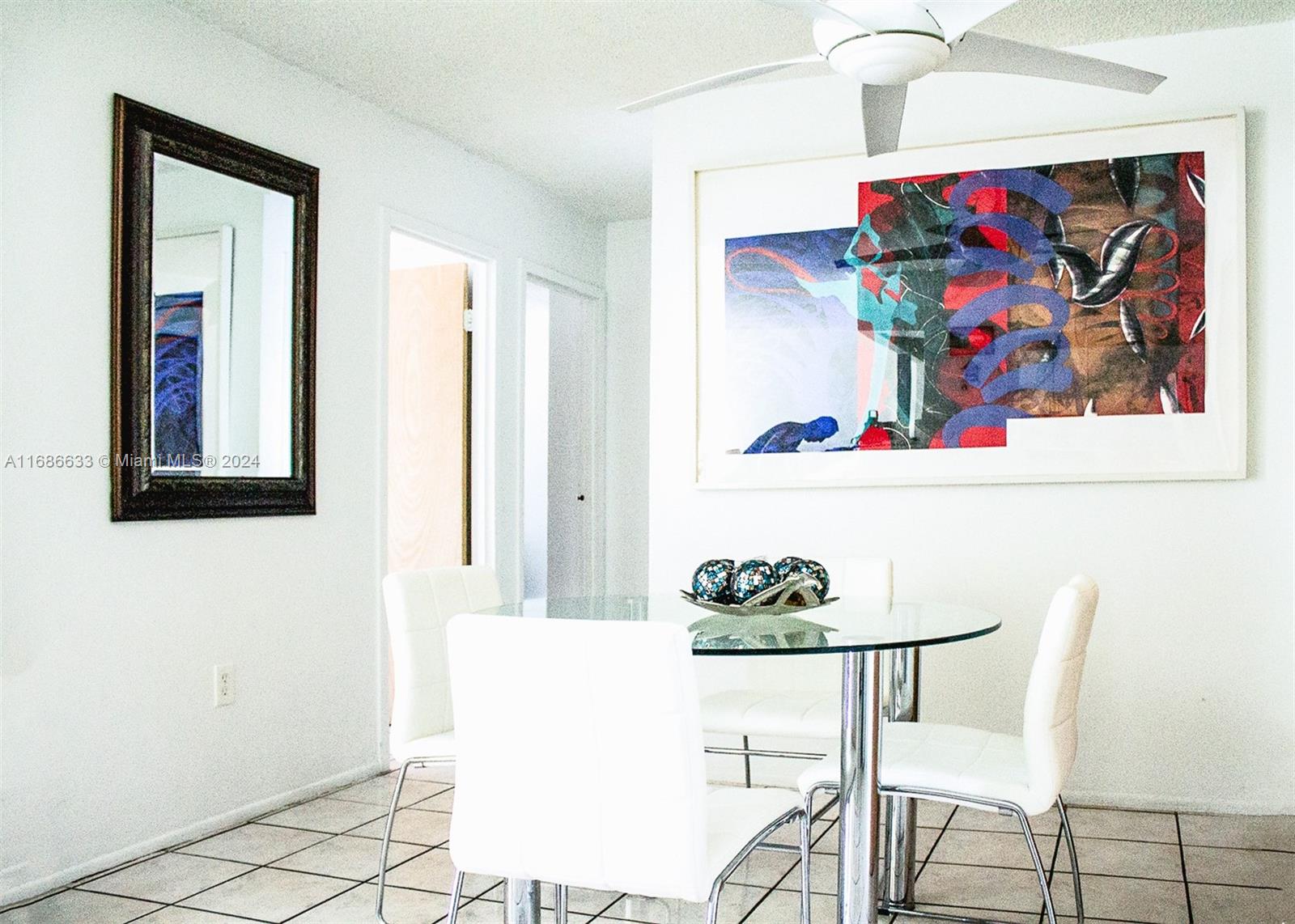 a view of a dining room with furniture and wall painting