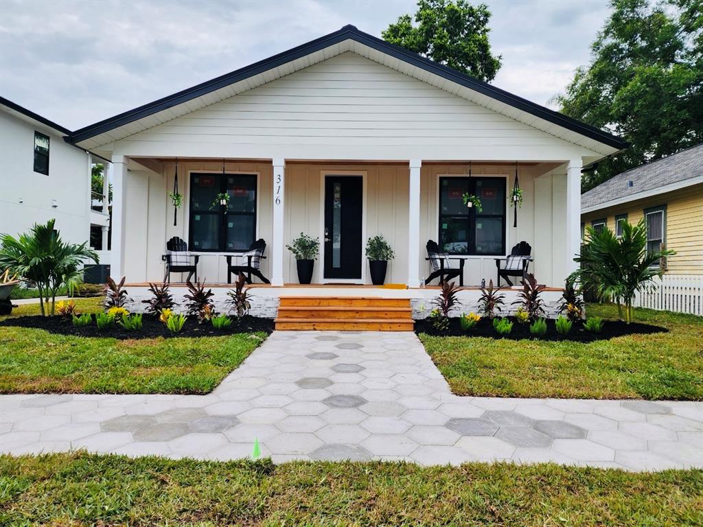 a front view of a house with yard and green space