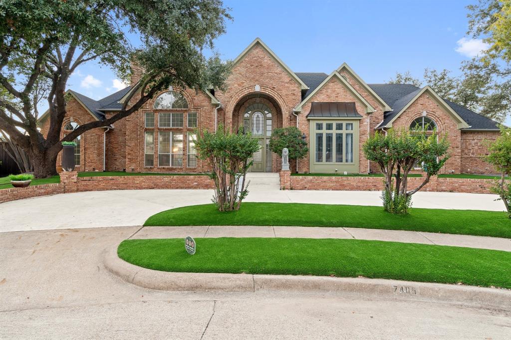 a front view of a house with a garden and plants