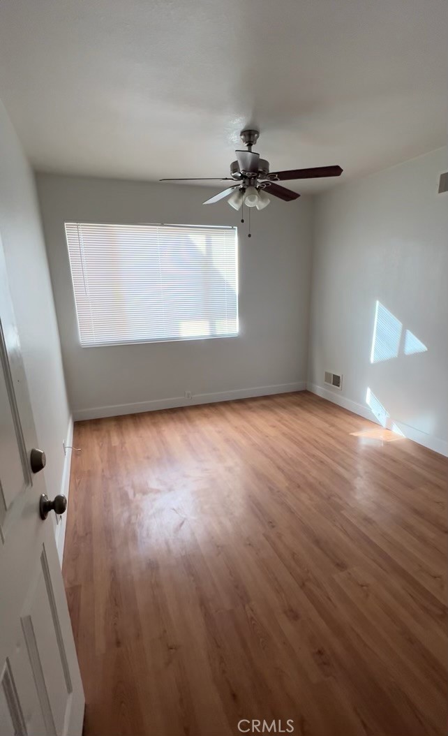 wooden floor in a hall with a window