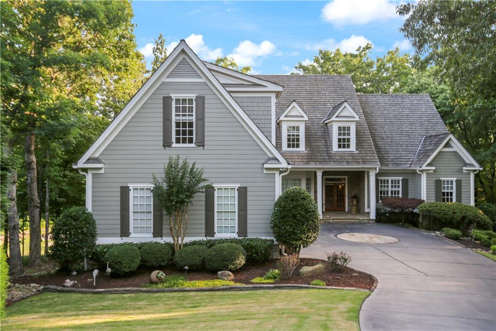 a front view of a house with yard and garage