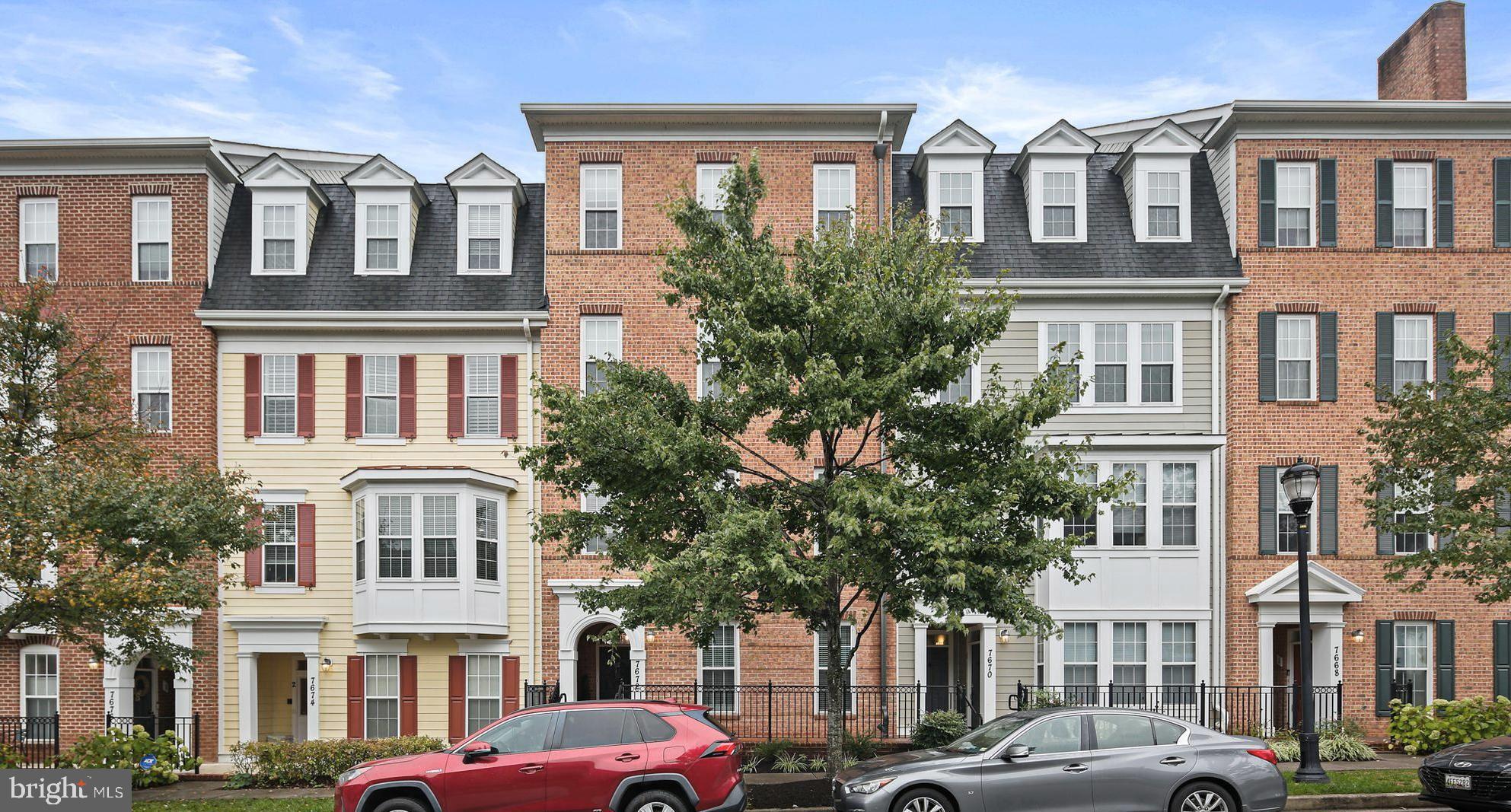 a front view of a residential apartment building with a yard