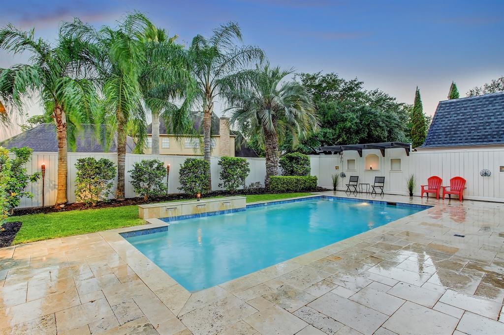 Spectacular sunroom overlooking tropical landscaping/sleek swimming pool, new Travertine decking & fountains