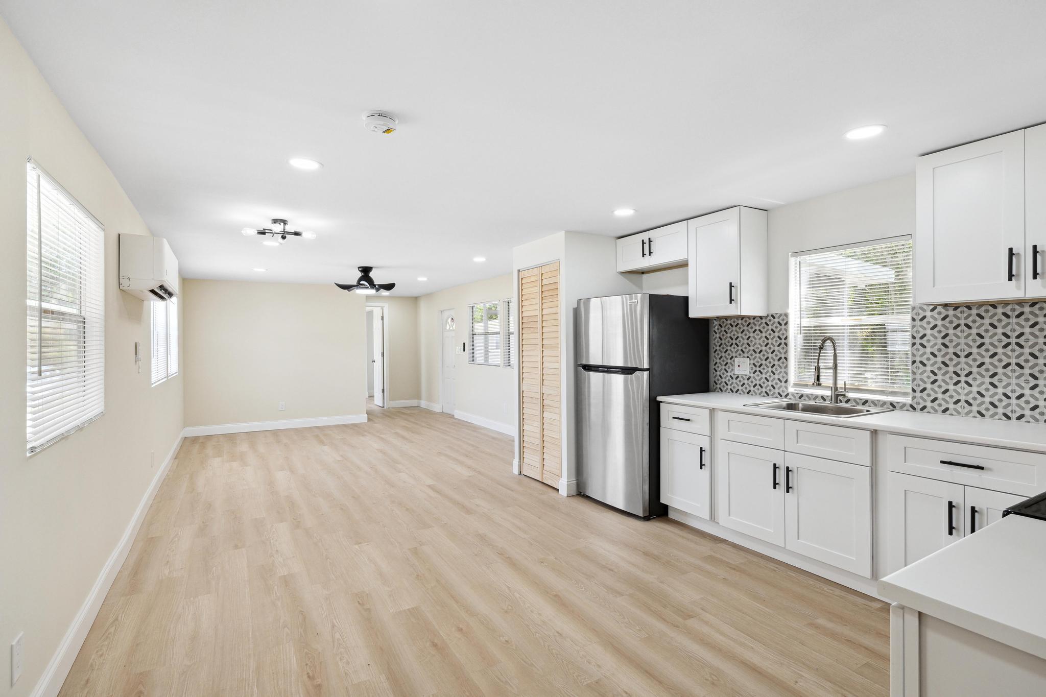 a kitchen with stainless steel appliances a refrigerator and a stove top oven