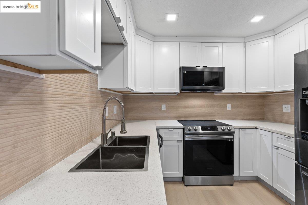 a kitchen with a sink stove and cabinets