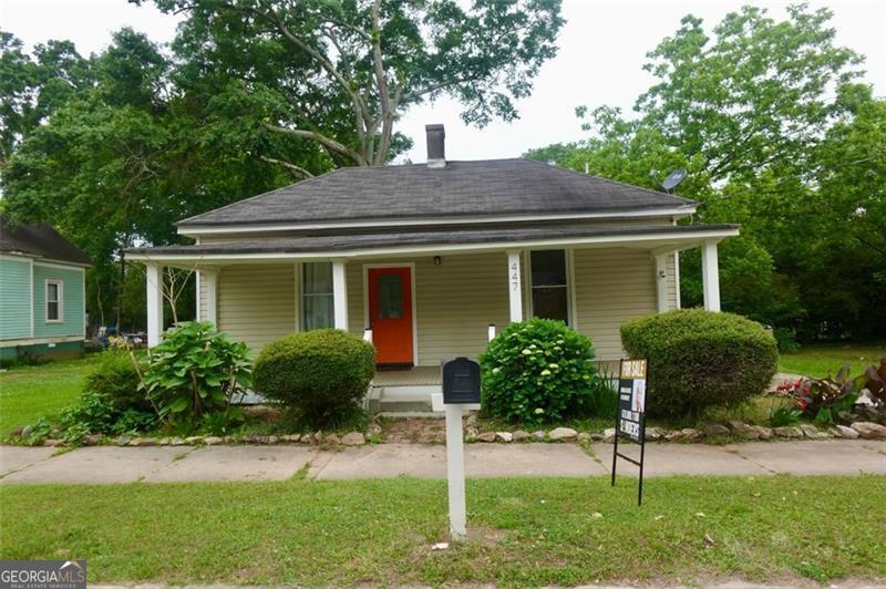 a house that has a tree in front of the house