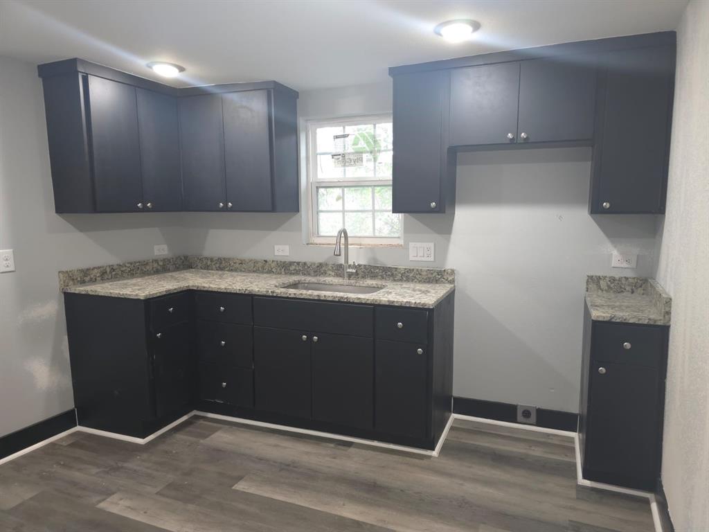 a kitchen with a sink and wooden cabinets