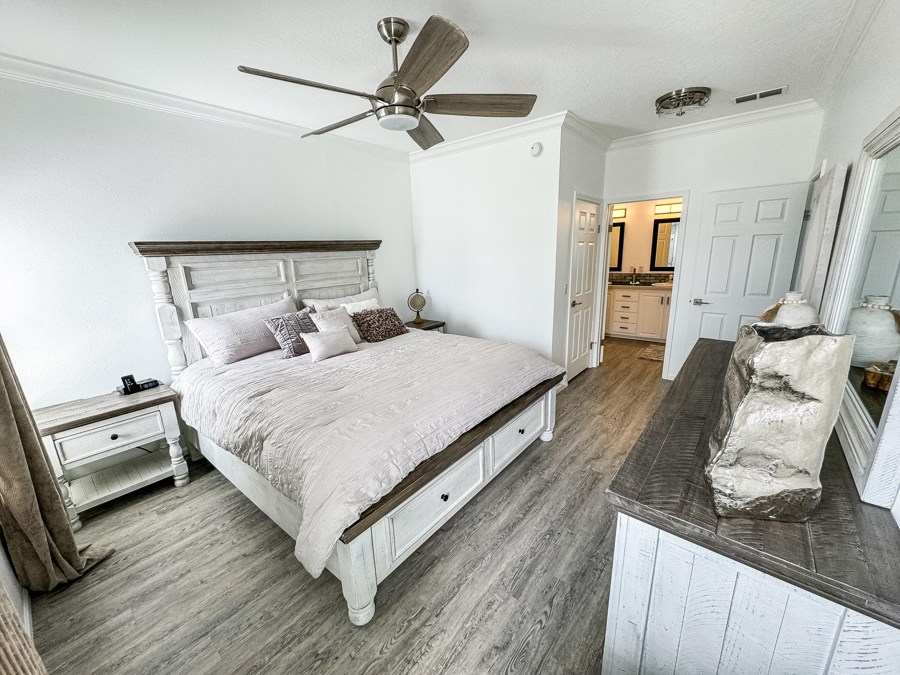 a bedroom with a bed and a flat tv screen on the dresser