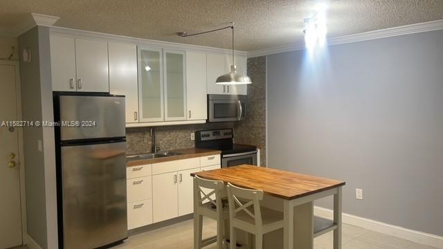 a kitchen with a refrigerator and a sink