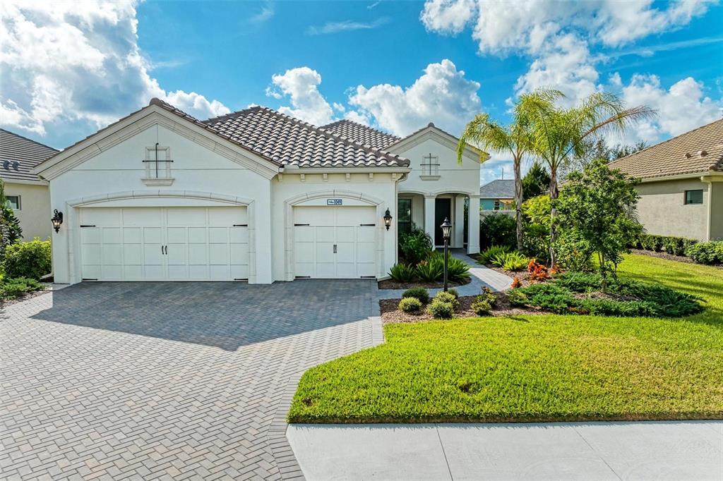 a front view of a house with a yard and garage