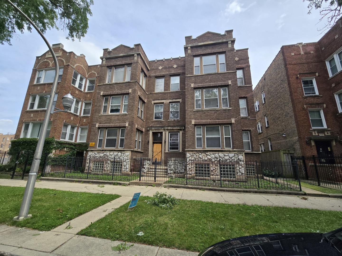 a front view of a residential apartment building with a yard