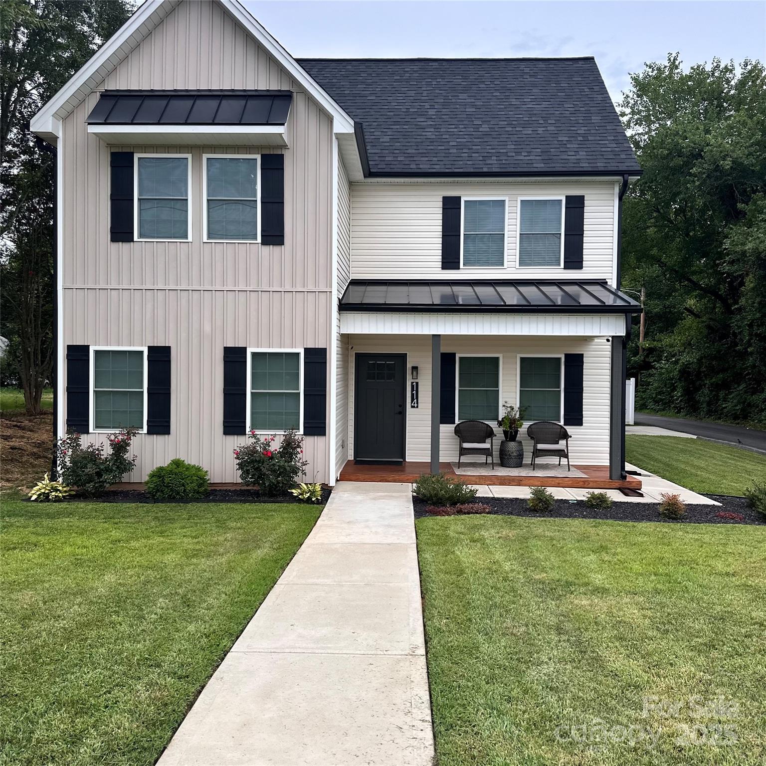 a front view of a house with garden and porch