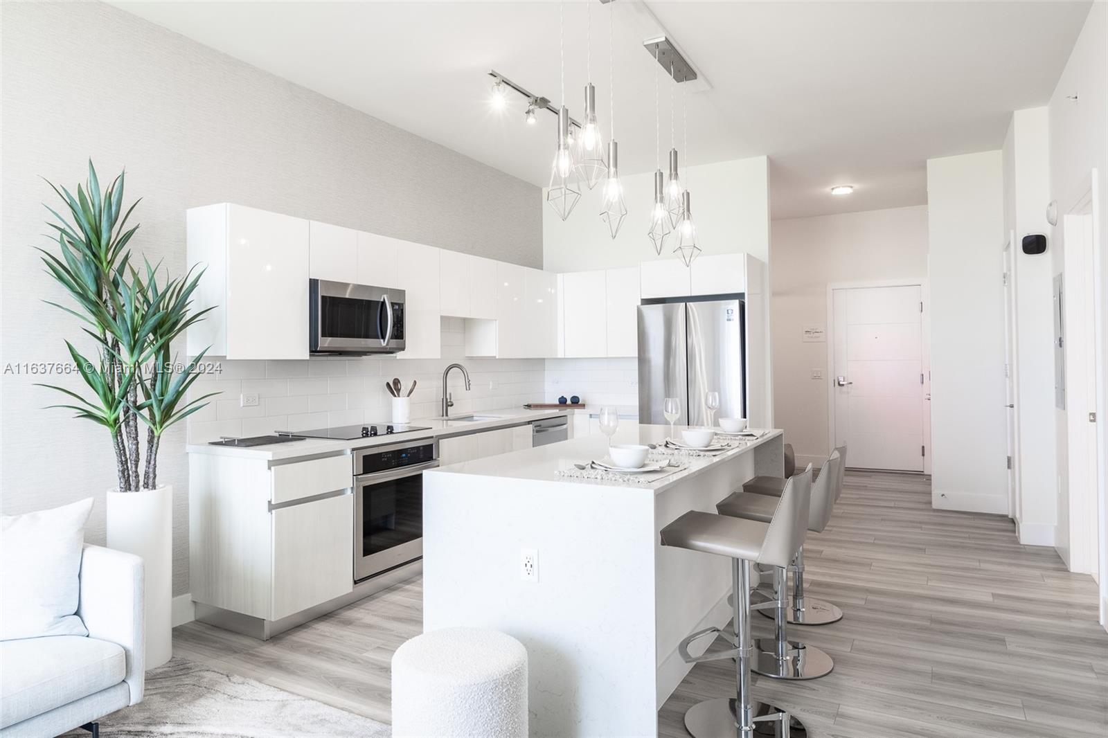 a view of kitchen with sink dining table and chairs