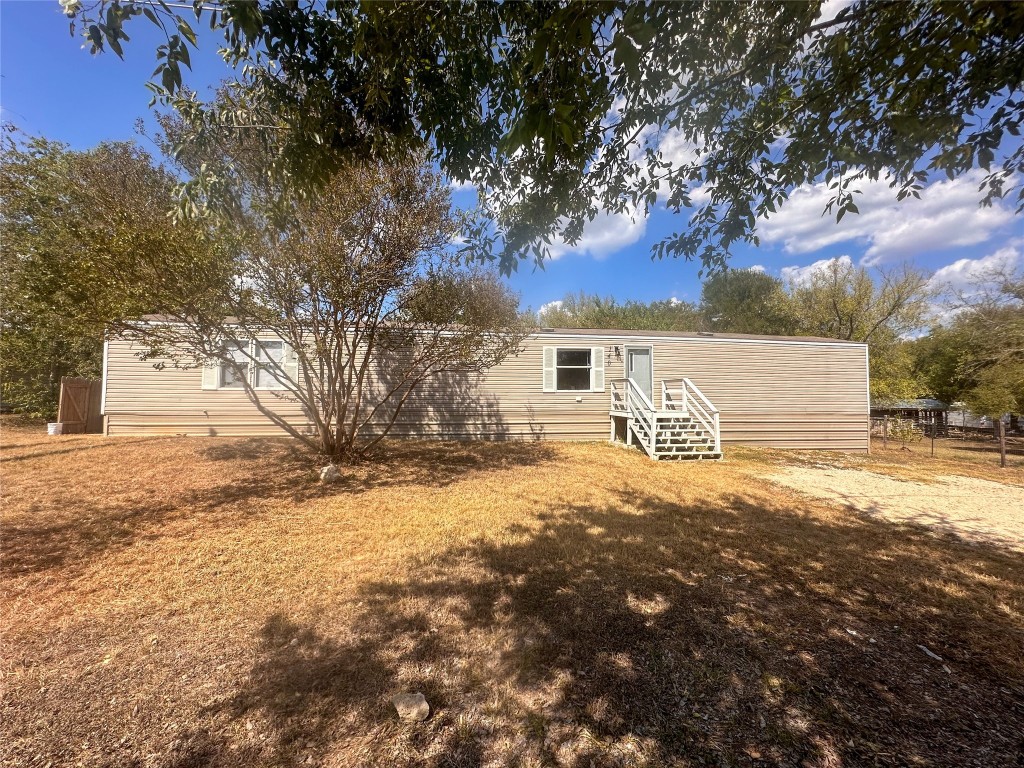 a view of a yard with a large tree