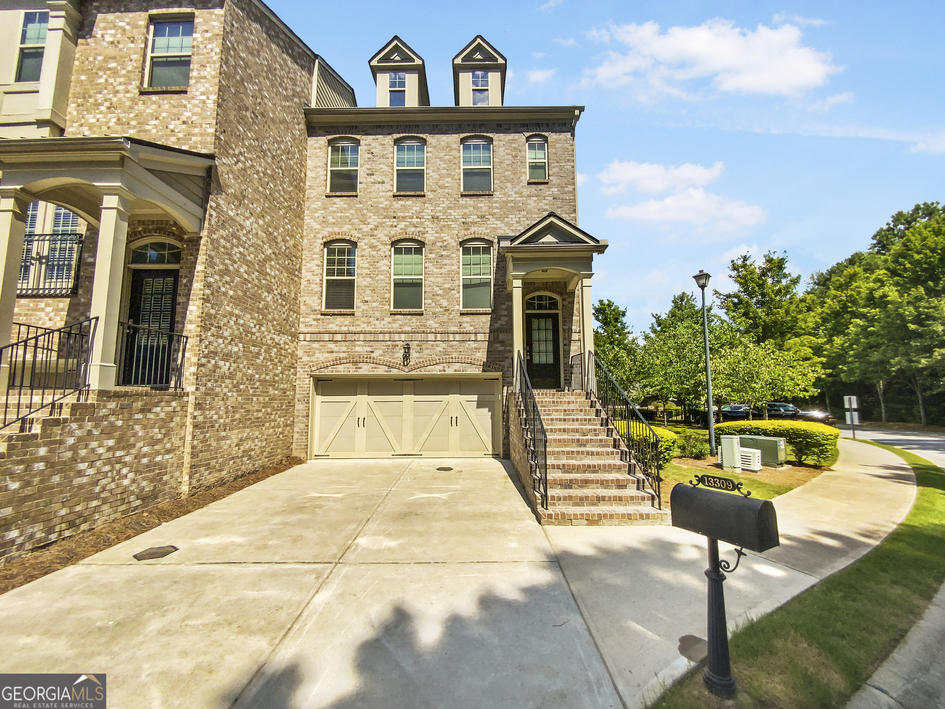 a view of a brick house with large windows