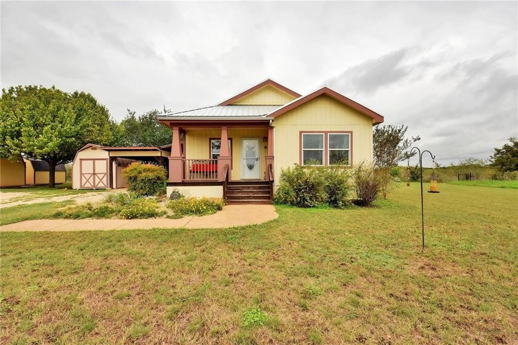 a front view of house with yard and green space