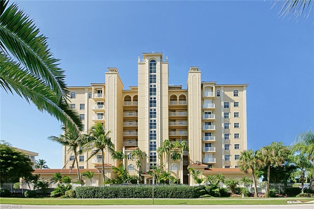 a front view of multi story residential apartment building with a yard