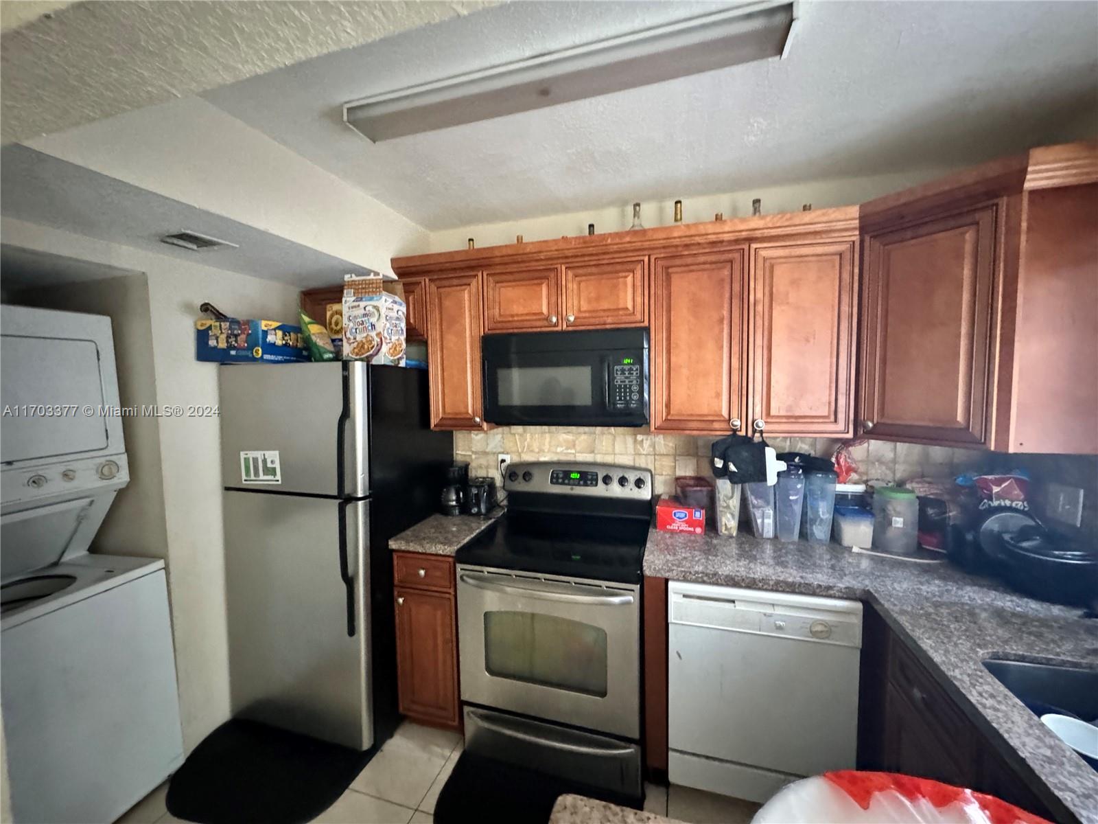 a kitchen with a refrigerator and a sink