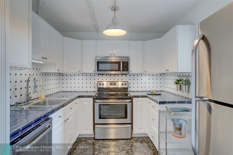 a kitchen with a sink stove and microwave