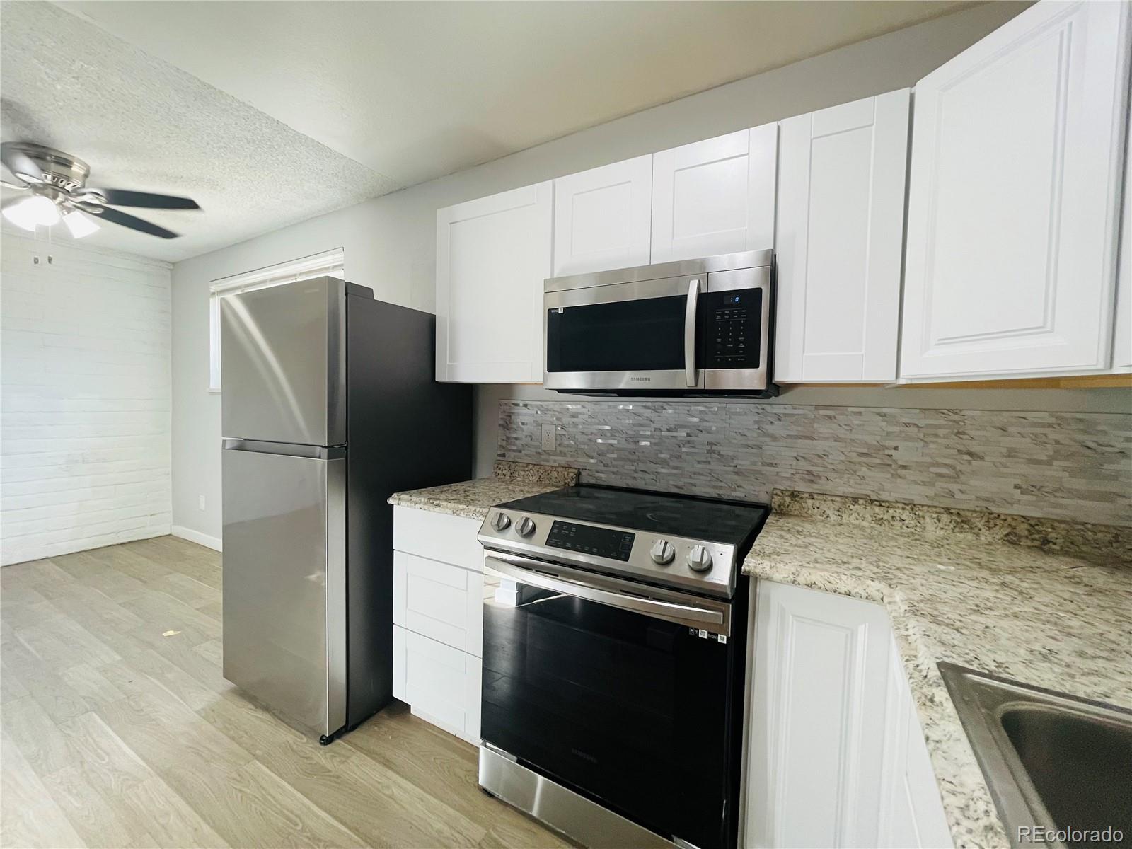 a kitchen with a refrigerator stove and microwave