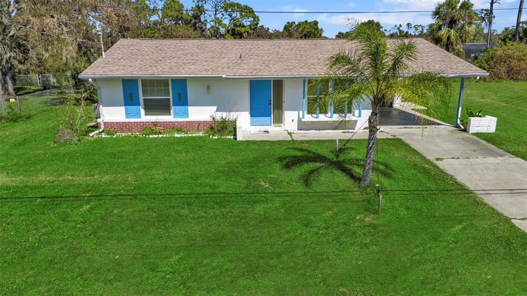 a front view of house with yard and green space