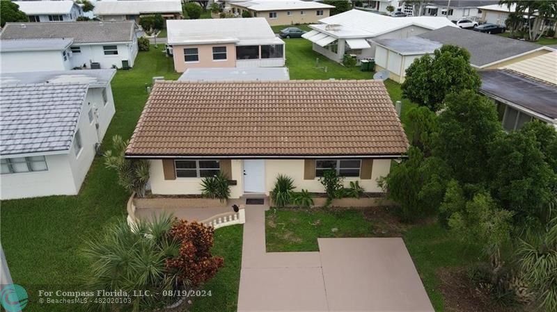 an aerial view of a house with yard patio and green space