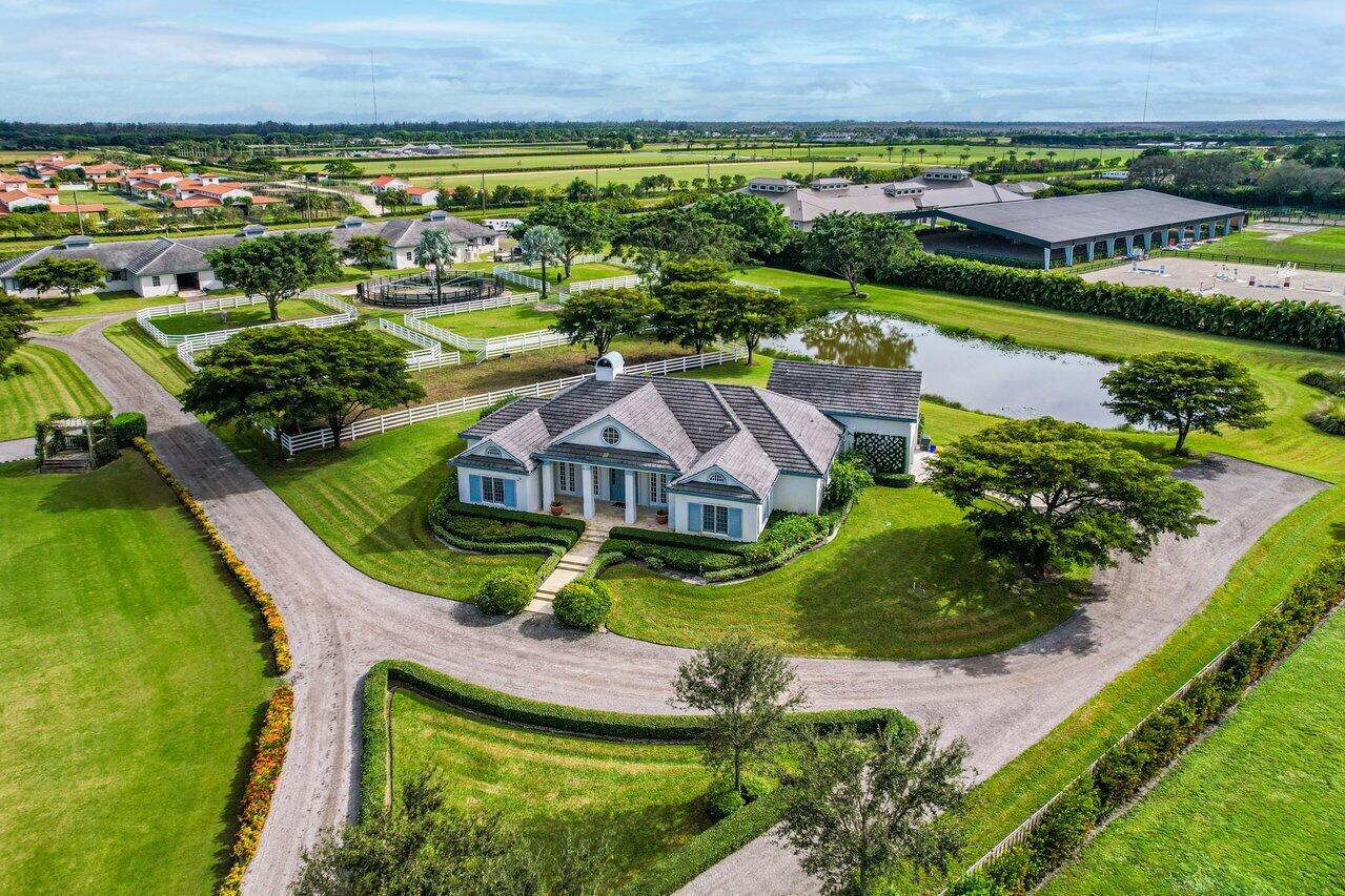 an aerial view of residential houses with outdoor space and river