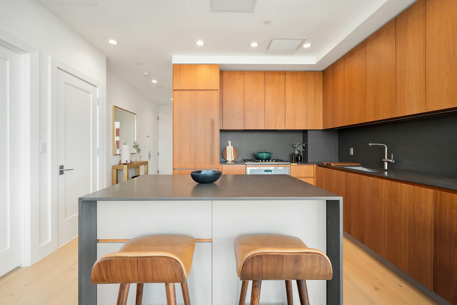 a kitchen with stainless steel appliances granite countertop a sink a stove and a refrigerator