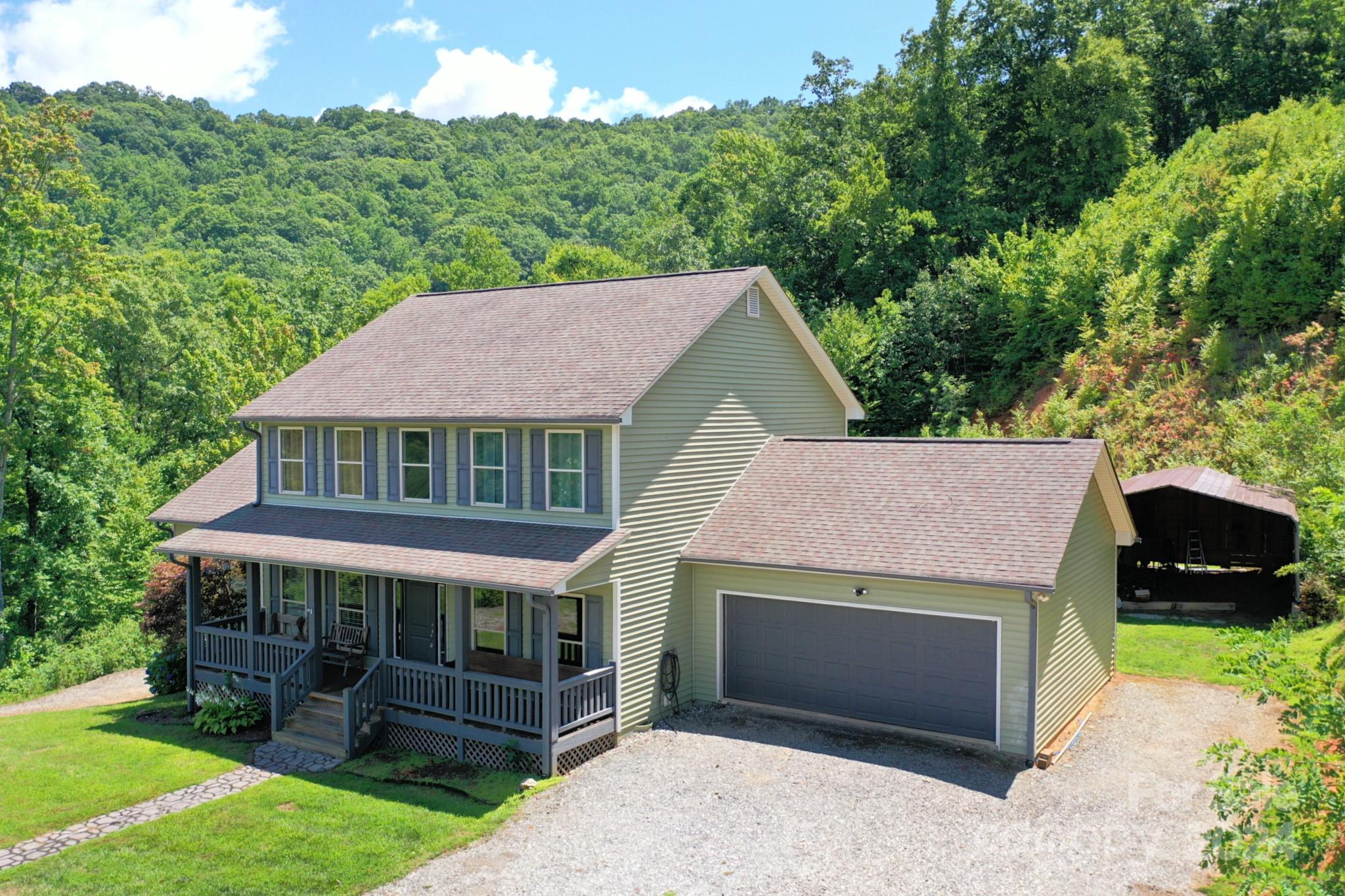 a aerial view of a house with a yard and a garden