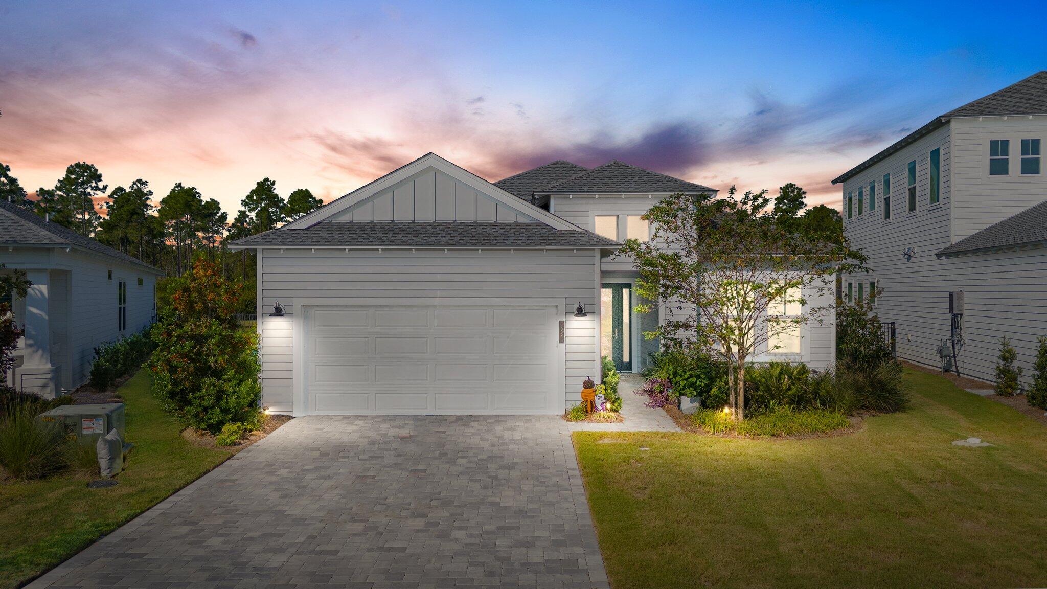 a front view of house with yard and green space