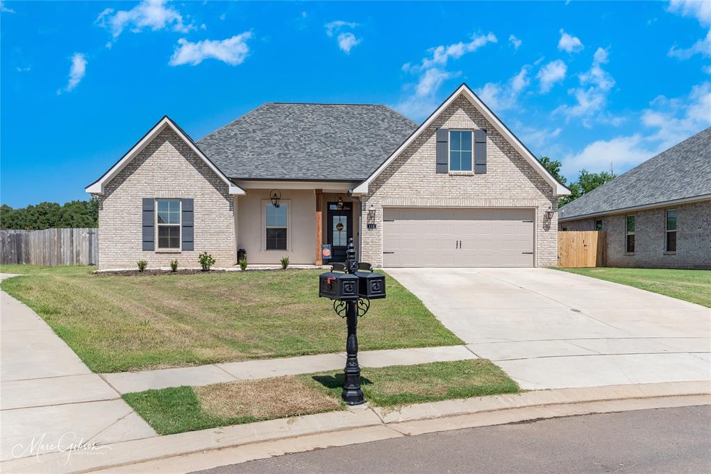 a front view of house with garage and yard