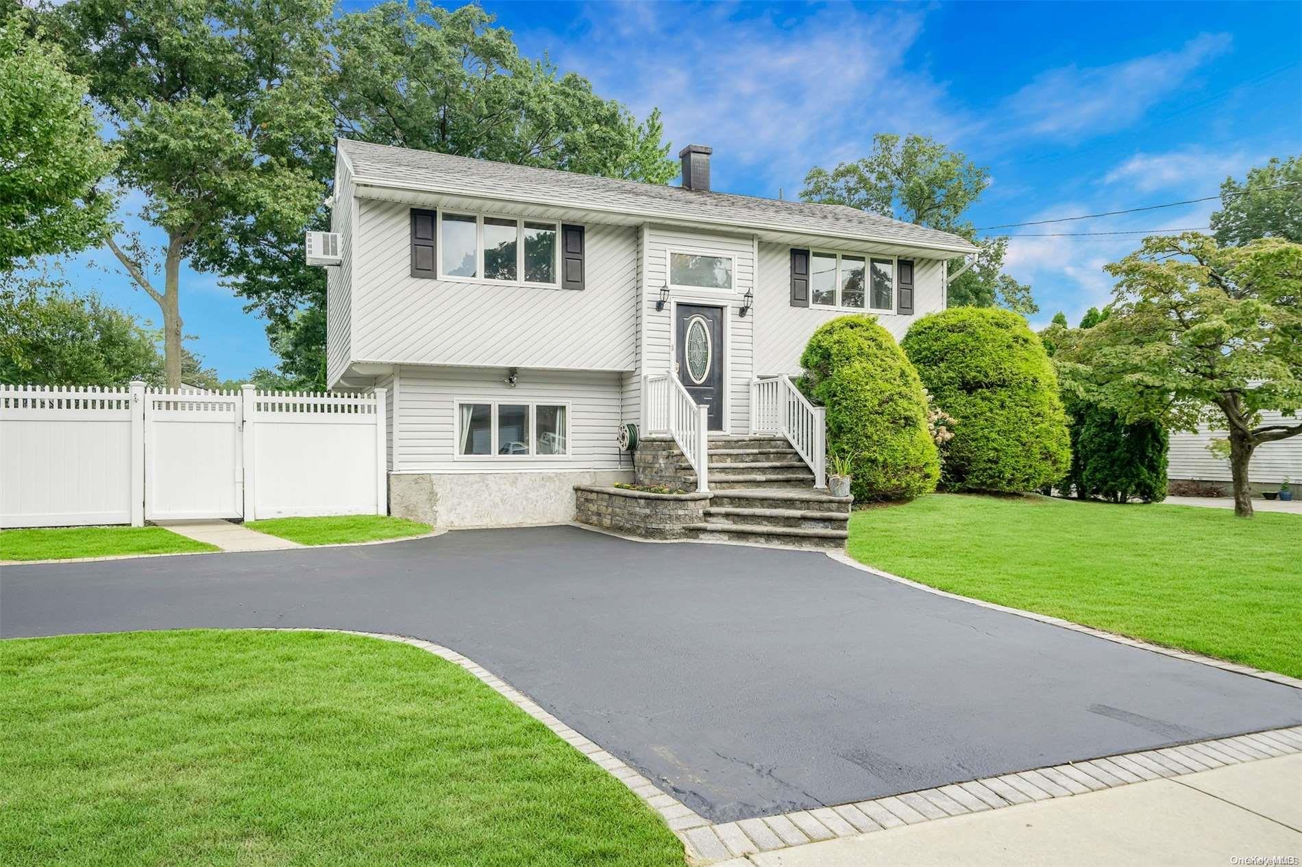 a view of a house with a yard and a patio