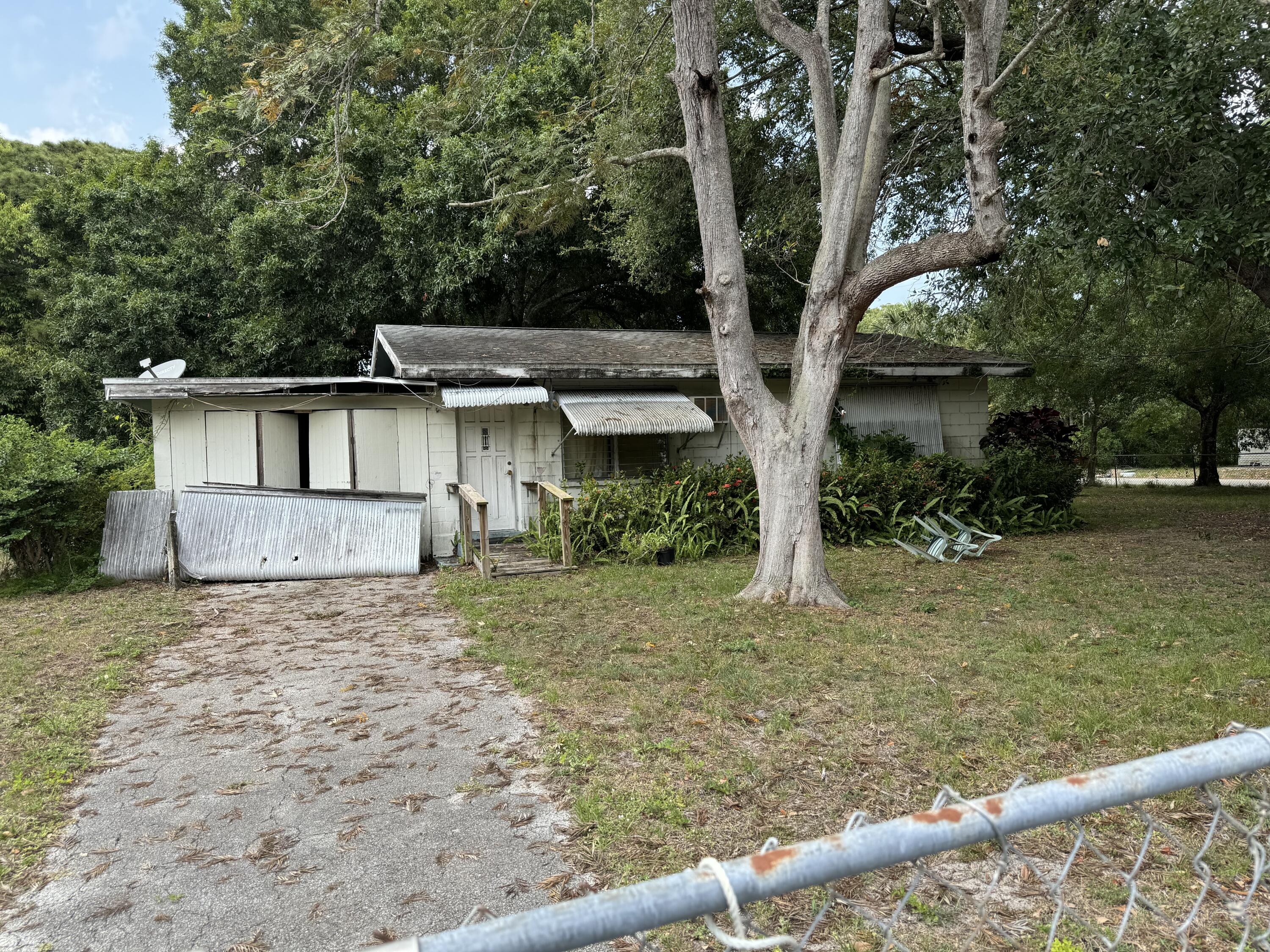 a view of a house with a tree in the yard