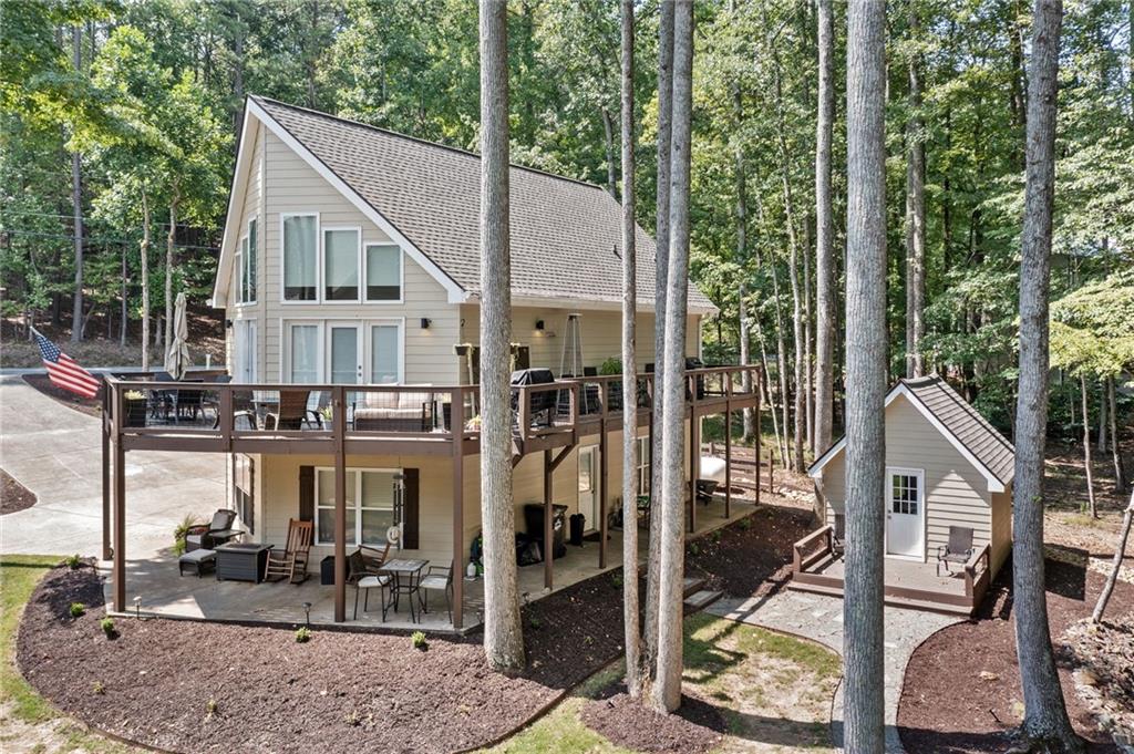 a view of a house with backyard and sitting area